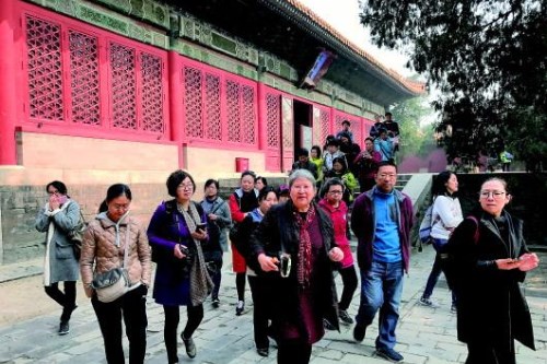 3月29日,在故宫文华殿的陶瓷馆,周娅(前排中)为参观者讲解后转至另一间展馆途中。记者 强晓玲 摄